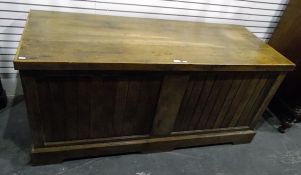 Large oak chest with hinged top above slatted panels, on raised bracket feet,
