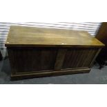 Large oak chest with hinged top above slatted panels, on raised bracket feet,