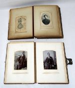 Two Victorian photograph albums containing portrait photographs and several postcards