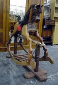 Wooden rocking horse with horse hair mane (has been cut) and tail, mounted on twin-pedestal support,