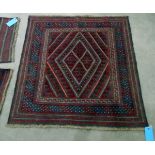 Kazak wool rug with central lozenge, having multiple hooked borders all in blue and red,