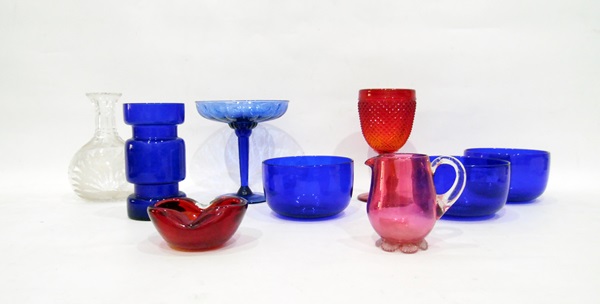 Three blue glass finger bowls, a cranberry glass jug, a red pressed glass goblet,