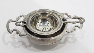 Early 19th century silver wine strainer, circular with ribbed rim, pierced shaped handles,