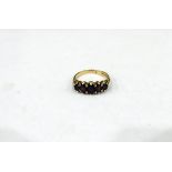 9ct gold garnet set ring with five graduated oval stones, 4g in total,