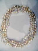 Three-strand champagne and cream baroque pearl necklace with gold coloured metal clasp, approx.