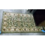 Pair of Eastern style rugs, green ground with floral decoration,