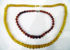 Graduated rough amber necklace and an amber-coloured plastic necklace (2)