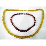 Graduated rough amber necklace and an amber-coloured plastic necklace (2)