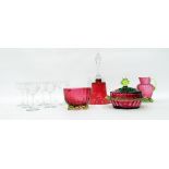 Collection of cranberry glass including a bell and a ball, covered dish,