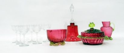 Collection of cranberry glass including a bell and a ball, covered dish,