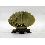 Carved jade model of a peacock with flower, on pierced base,