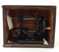 Late 19th century C-framed sewing machine, undecorated, with turned wood handle,