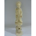 Carved Chinese ivory puzzle ball figure of mandarin holding scepter, above puzzle ball, height 17.