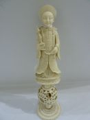 Carved Chinese ivory puzzle ball figure of mandarin holding scepter, above puzzle ball, height 17.