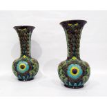 Pair of Burmantoft Faience vases of bottle form with flared rims, decorated with flowers, in yellow,