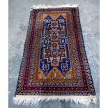 Persian style wool rug, orange decorations on a maroon ground,
