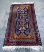 Persian style wool rug, orange decorations on a maroon ground,