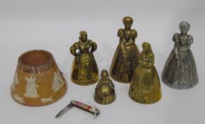 Five brass table bells of varying sizes, modelled as ladies,
