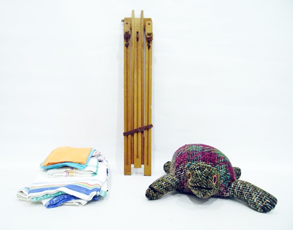 Folding artist's easel and a quantity of textiles including a knitted turtle