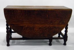Oak gateleg dining table with richly veined top, rounded flaps, two frieze drawers,