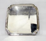 1930's silver salver, square-shaped, on four scroll feet,