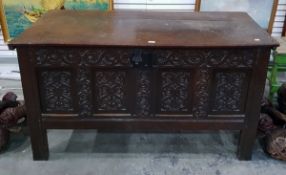 Antique oak coffer with quadruple panelled front, all scroll carved and with channelled stiles,