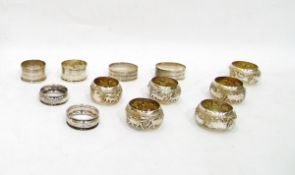 Three pairs of silver napkin rings and a set of six continental silver napkin rings of repousse