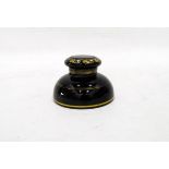 Victorian black glass inkwell of shallow circular form, decorated with gold bands,
