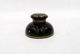 Victorian black glass inkwell of shallow circular form, decorated with gold bands,