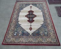 Medium sized Eastern style rug, dark maroon border with cream and blue design,