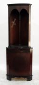 Reproduction mahogany corner cabinet with perspex shelves, open fronted, with a carved frieze,