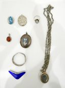 Silver locket on chain, sundry silver rings, silver and enamel boomerang shaped brooch, marked TYA,