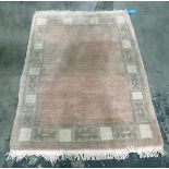Chinese style wool rug in pastel shades of pink and celadon green,