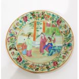 Pair of Chinese famille rose porcelain plates on a green ground, decorated with figures,