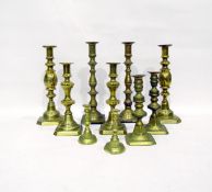 Pair of brass candlesticks of knopped form with circular motifs to the centre and four further