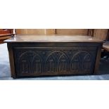 Reproduction oak coffer with carved front,