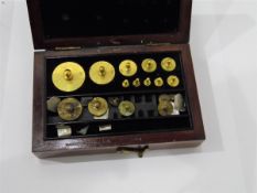 Set of brass weights in box, the box labelled 'Marmbrunn, Quartz & Co,