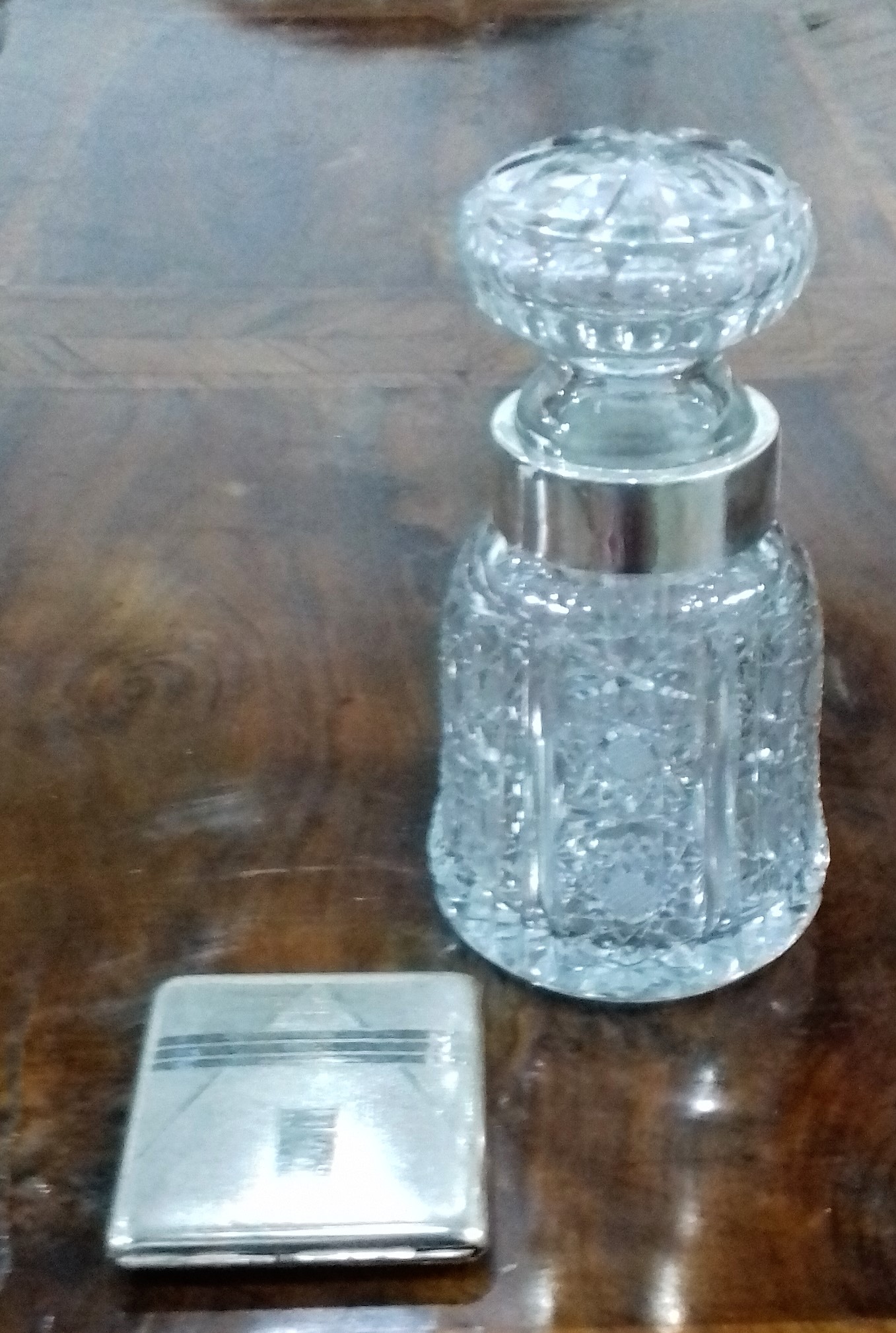 Cut glass bottle and stopper with silver-coloured metal rim,
