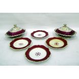 Set of four 19th century plates decorated with a flower motif within a burgundy and gold rim and a