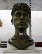 Plaster bronzed-effect bust of a young woman with her hair up,