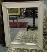 Cream framed rectangular wall mirror with green highlighted detail,