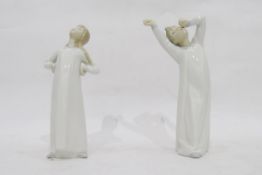 Two Lladro figures of children, one of a girl and the other of a boy stretching,