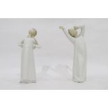 Two Lladro figures of children, one of a girl and the other of a boy stretching,