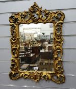 Rectangular gilt framed wall mirror with scroll decoration,