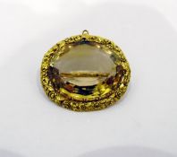 Gold and oval citrine set brooch, the gold mount floral decorated,