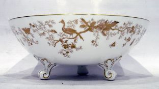 Coalport bowl decorated in gold with exotic birds, on a white ground, on three scrolling feet,