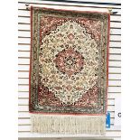 Silk prayer rug showing animals, with a central cartouche, all on a pale rust-coloured ground,