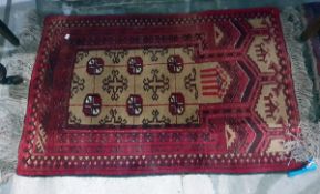 Small Persian wool rug, red ground with cream and black geometric pattern,