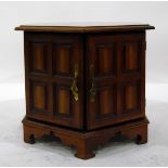 Octagonal top table with panelled cupboards below, on bracket feet,