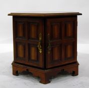 Octagonal top table with panelled cupboards below, on bracket feet,